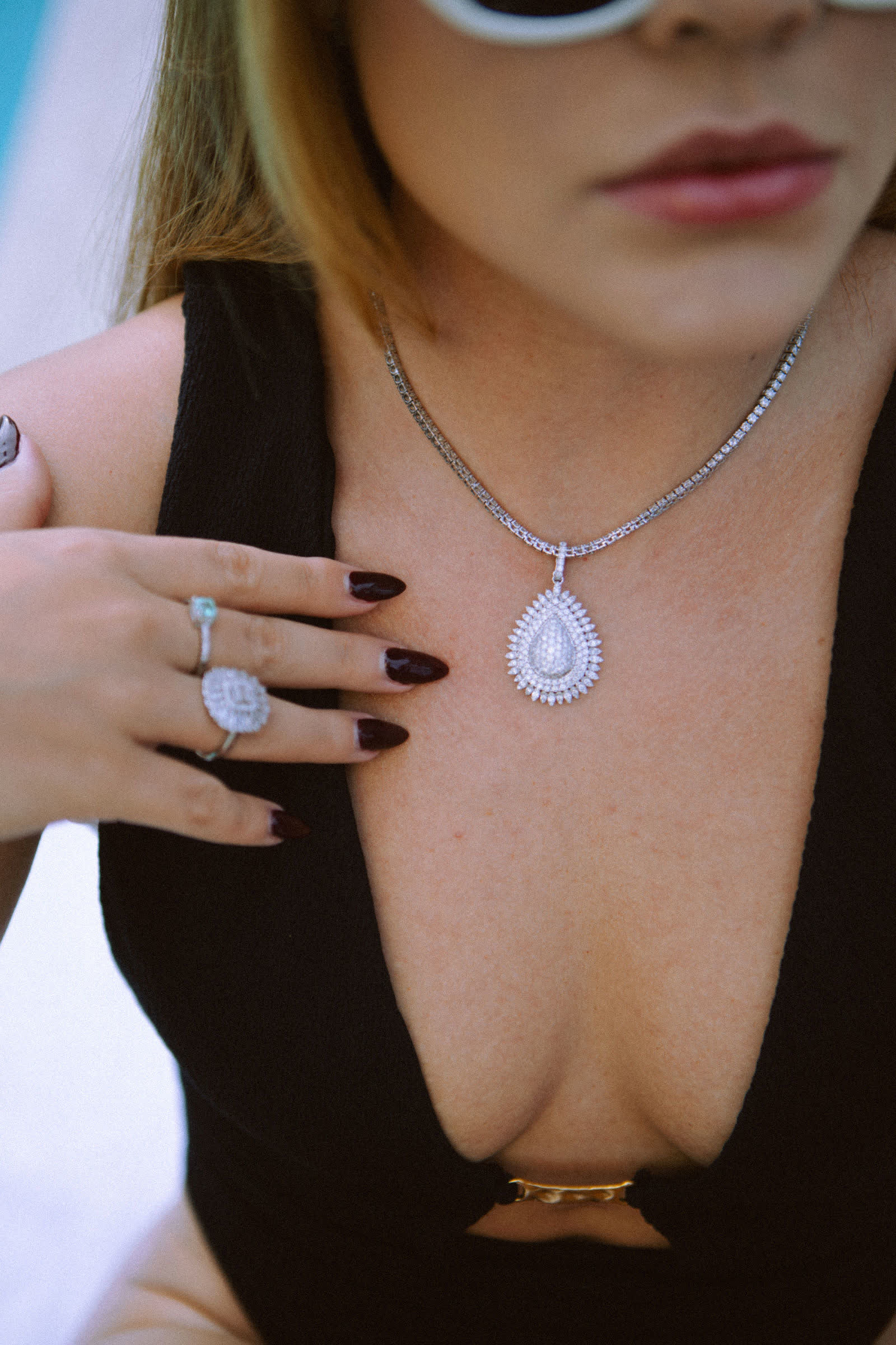 The Eternal Drop Necklace on a diamond riviera, with the Imperial Ring and a cuff