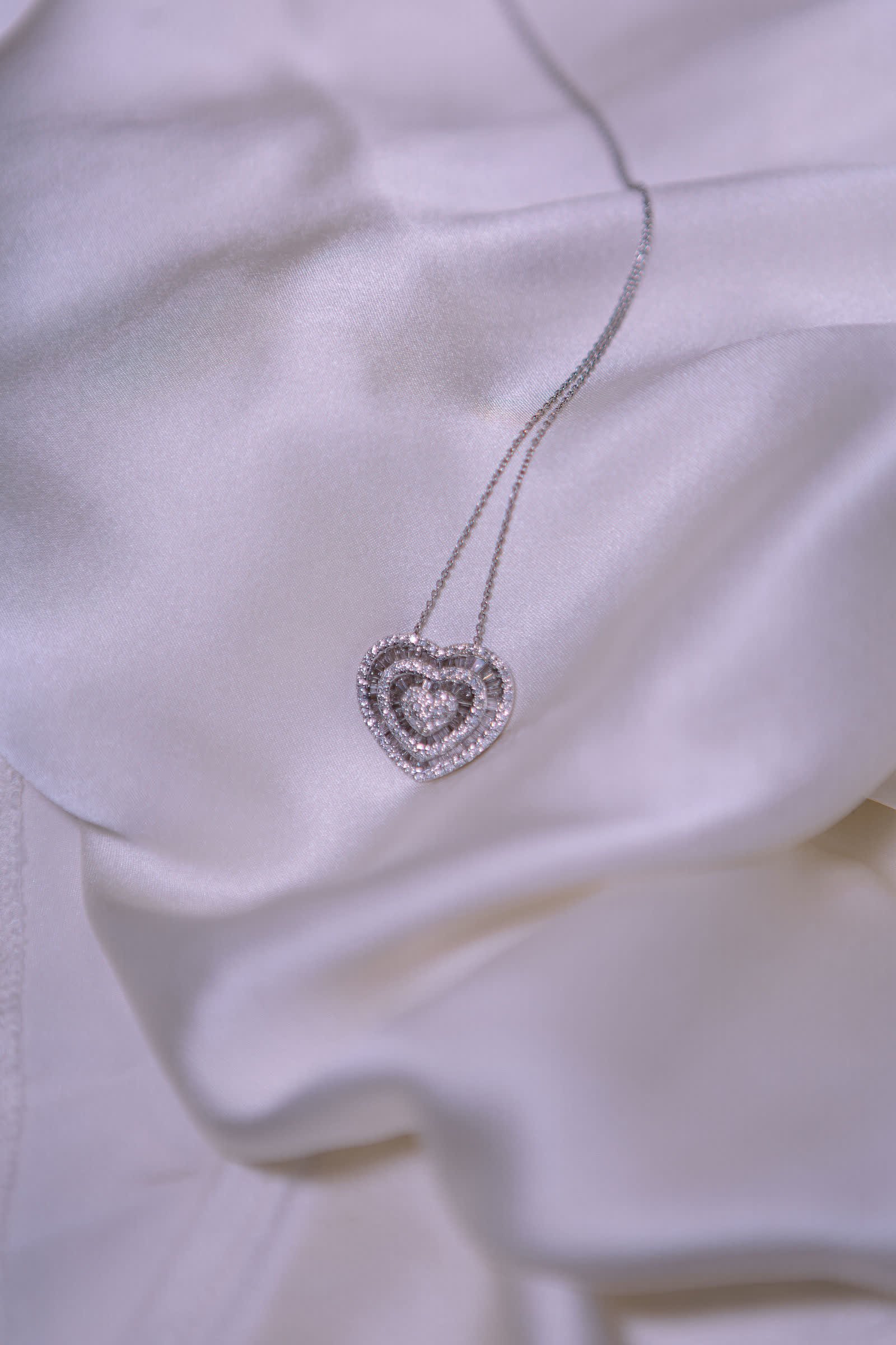 Heart Pendant — A two-tier diamond heart on a fine chain.