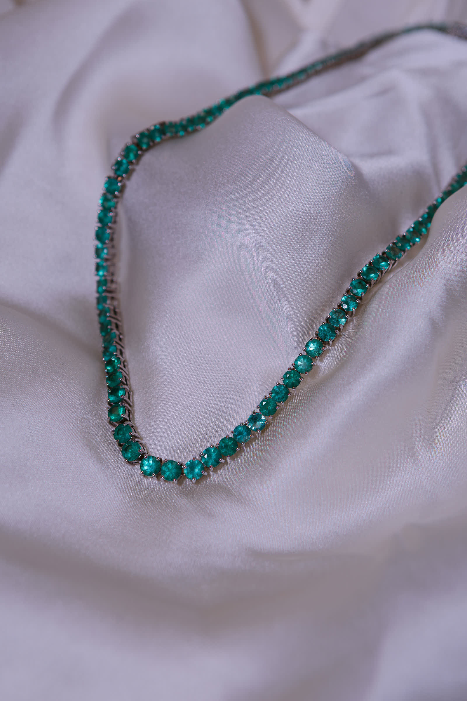 Emerald Riviera Necklace — A riviera worked entirely in round emeralds.